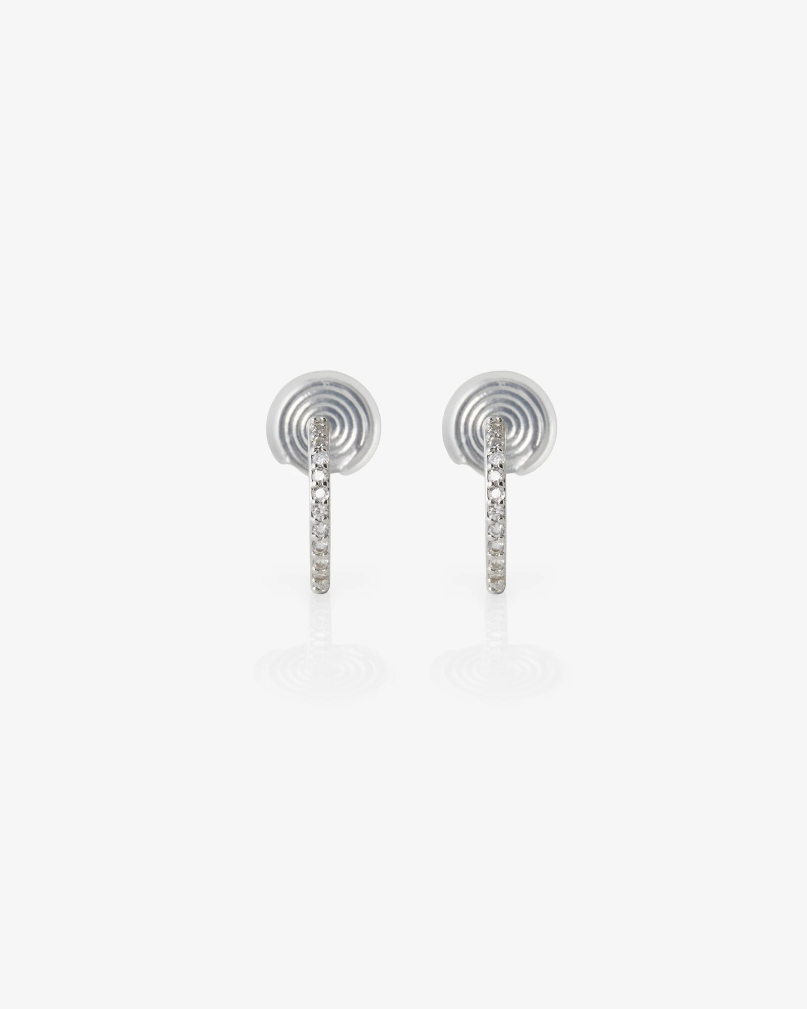 Pair of silver earrings with gemstones on a white background