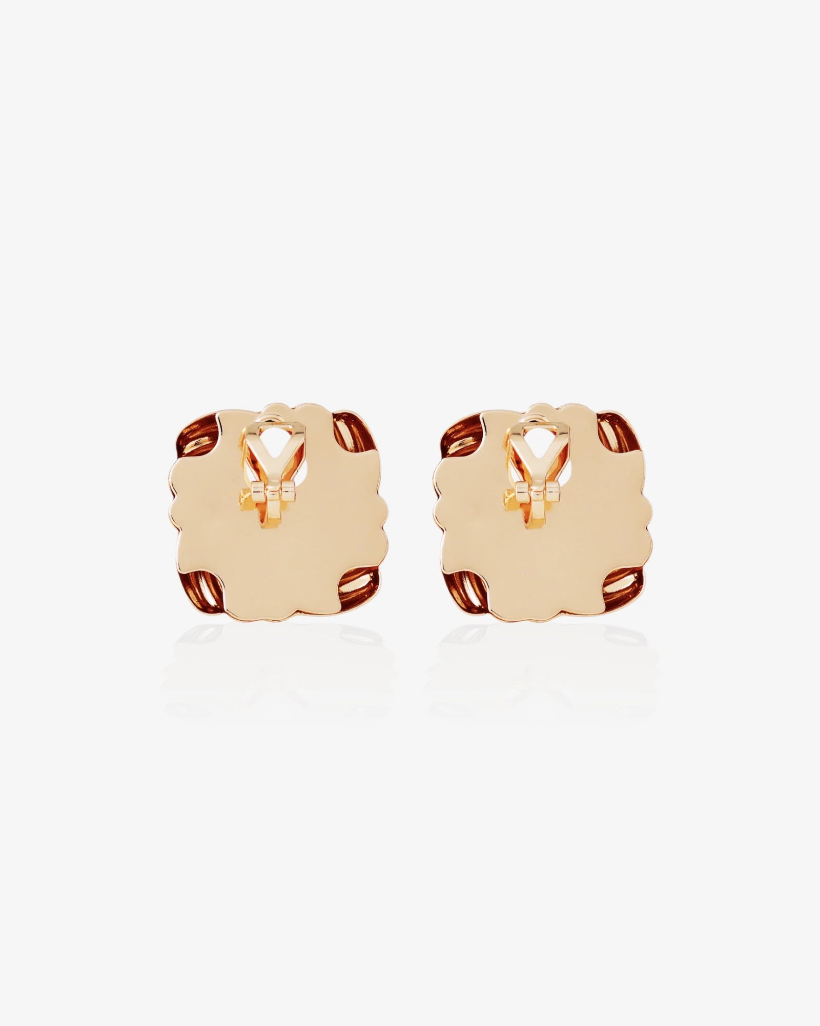 Pair of gold hoop earrings on a light gray background