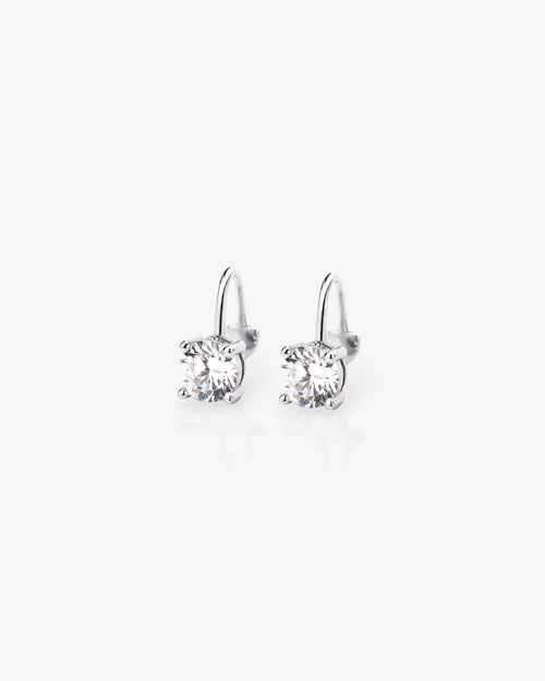 Pair of silver earrings with clear gemstones on a white background