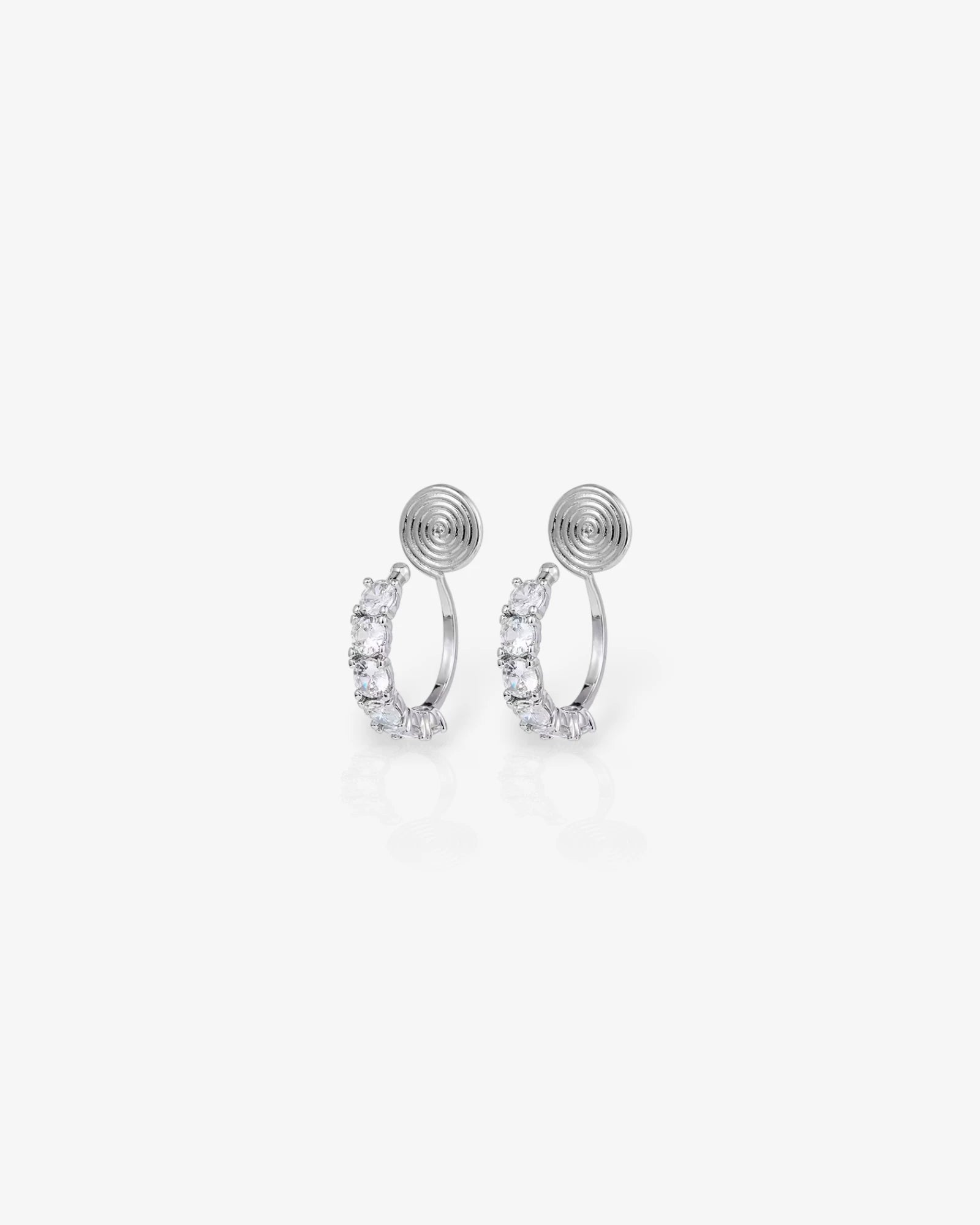 Pair of silver hoop earrings with small round embellishments on a white background