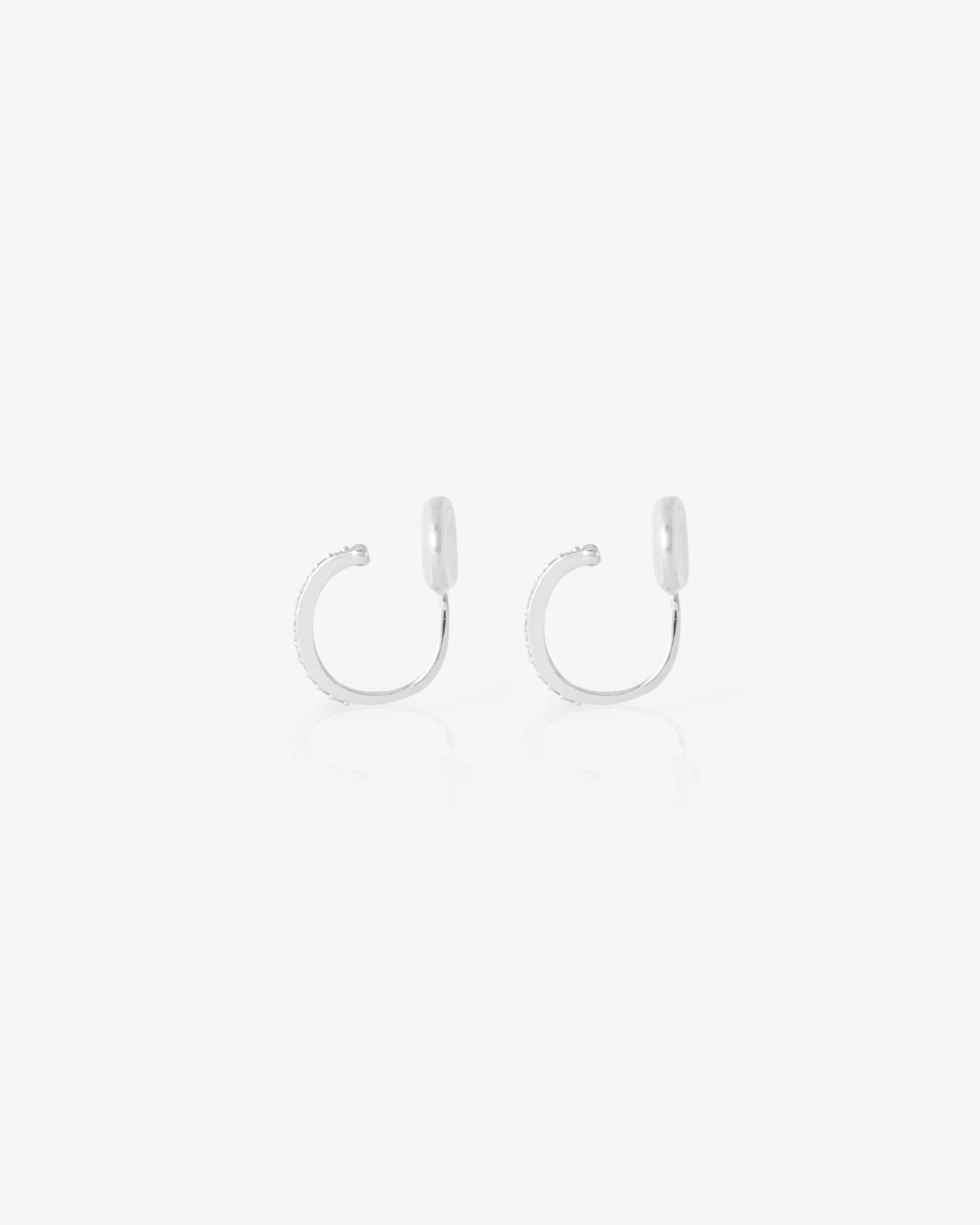 Pair of silver hoop earrings on a light gray background