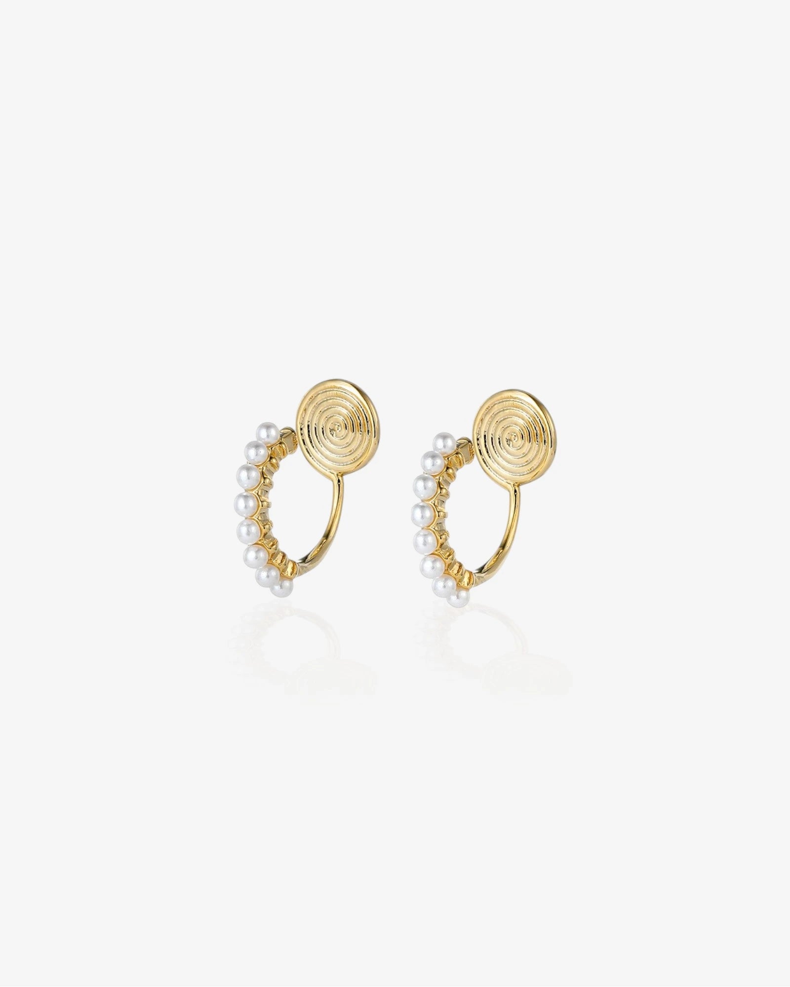Gold earrings with pearl accents on a white background