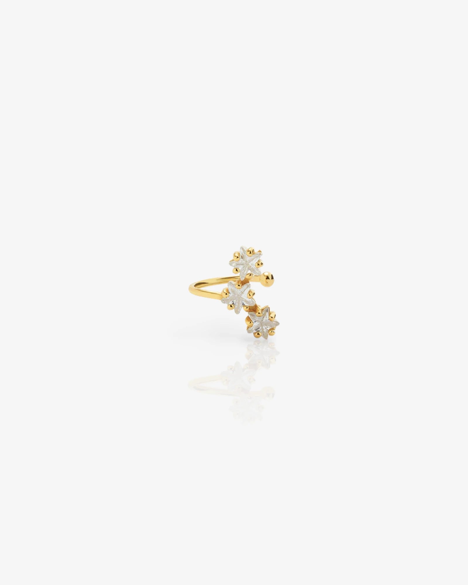 Gold ear cuff with star design on a white background