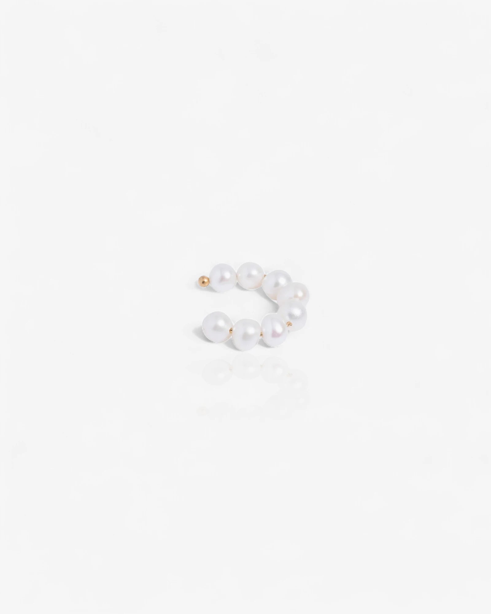Pair of pearl ear cuff on a white background