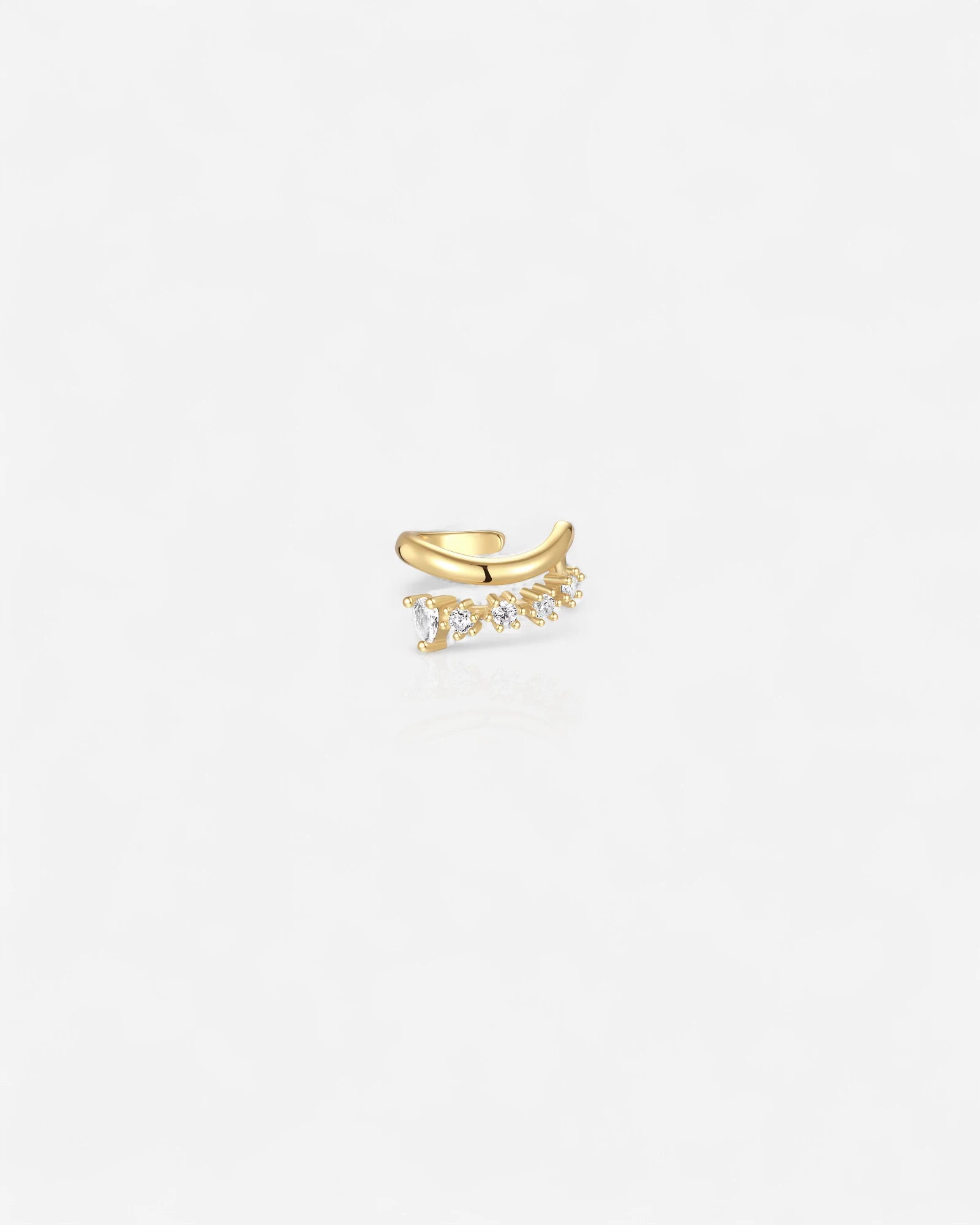 Gold ear cuff with small diamonds on a white background